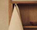 Frama Shelf Library Canvas Cabinet in Natural Oak and Canvas, close up of the canvas front lifted on a hook to show the oak interior shelf