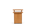 Frama Ratio Side Table in Warm Brown Birch, small birch cabinet with a closed door and a floating top panel raised on short posts