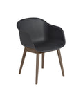 black fiber armchair with dark stained wood base by muuto