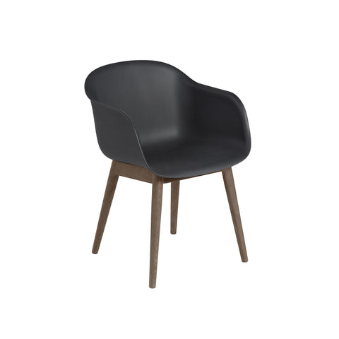 black fiber armchair with dark stained wood base by muuto