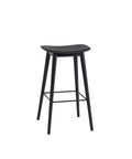 muuto Fiber Bar Stool with wood legs and no back rest, black seat and black base