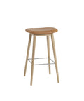 muuto Fiber Bar Stool with wood legs and no back rest, refine leather cognac seat and oak base