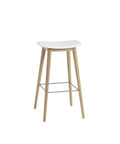 muuto Fiber Bar Stool with wood legs and no back rest, white seat and oak base