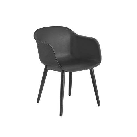 black fiber armchair with wood base designed by muuto
