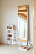 Form & Refine A Line Mirror, solid oak floor mirror, oak floor mirror leaning against a wall next to the A Line Shoe Rack in a bright hallway