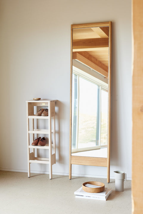 Form & Refine A Line Mirror, solid oak floor mirror, oak floor mirror leaning against a wall next to the A Line Shoe Rack in a bright hallway
