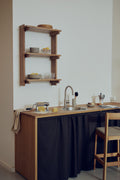 Form & Refine Beam Shelf 3, solid pine wall shelf, deep brown pine wall shelf in a small kitchen with a bar stool at the counter