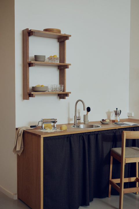 Form & Refine Beam Shelf 3, solid pine wall shelf, deep brown pine wall shelf in a small kitchen with a bar stool at the counter
