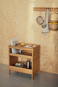 Form & Refine Echo Coat Rack 88, solid oak wall coat rack, oak coat rack with a sieve and basket above the Journal Organiser against a plywood wall