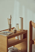 Form & Refine Journal Organiser, solid oak organiser table, the Journal Organiser holding vases, brushes and a book, close view