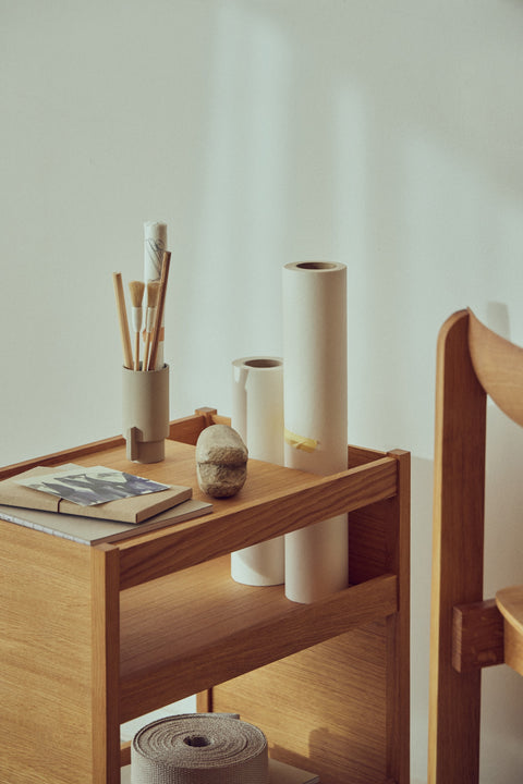 Form & Refine Journal Organiser, solid oak organiser table, the Journal Organiser holding vases, brushes and a book, close view