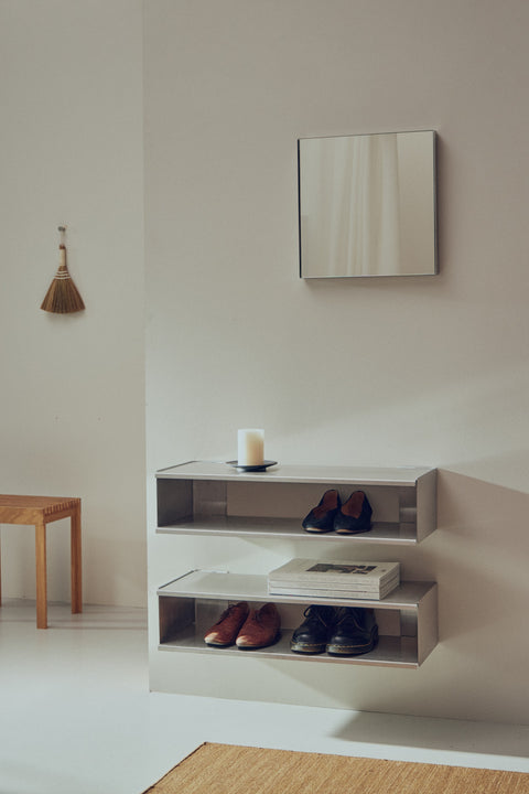 Form & Refine Lightweight Stool, solid oak stool, steel Taper console with shoes and a candle beside a square mirror in a hallway