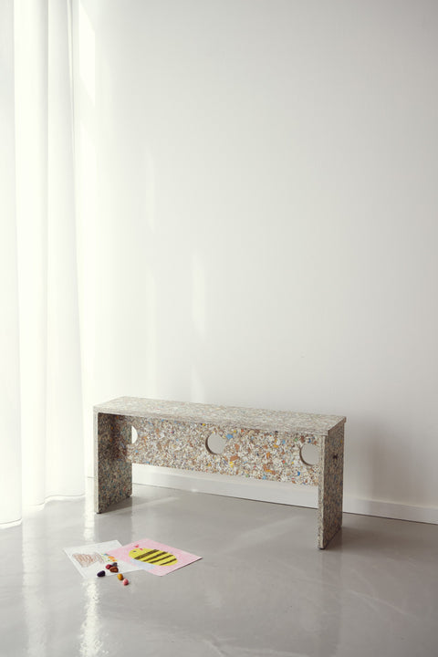 Form & Refine Remake Bench, recycled carton bench, the recycled-carton bench in a bright room with papers on the floor