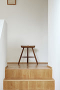 Form & Refine Shoemaker Chair™, No. 49, wooden Shoemaker stool, smoked oak Shoemaker stool on an oak landing at the top of a stair