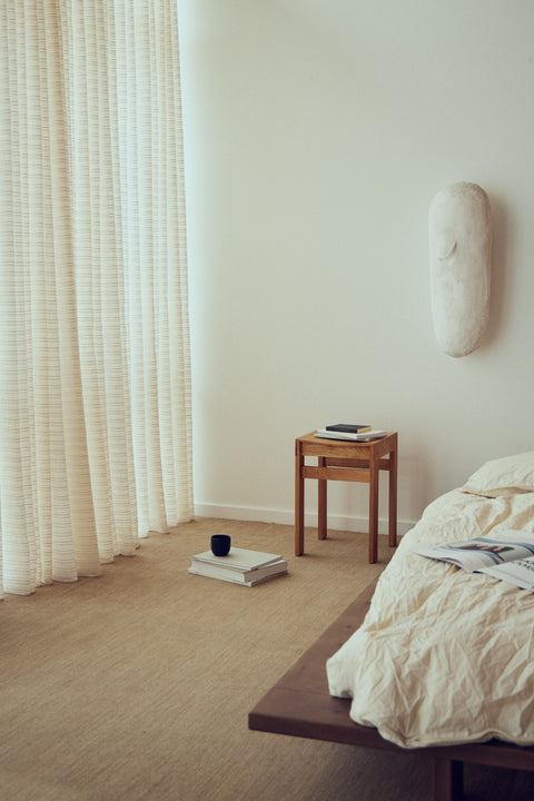 Form & Refine Sonder Stool, solid oak low stool, oak stool used as a bedside table beside a low bed by sheer curtains