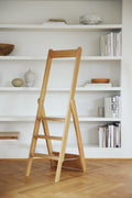 Form & Refine Step by Step Ladder, folding oak ladder, oak ladder folded flat against white bookshelves