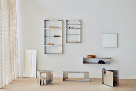 Form & Refine Taper Cube Box 34x35, brushed stainless steel wall cube, the steel Taper series arranged along a white wall, shelves, cube and console