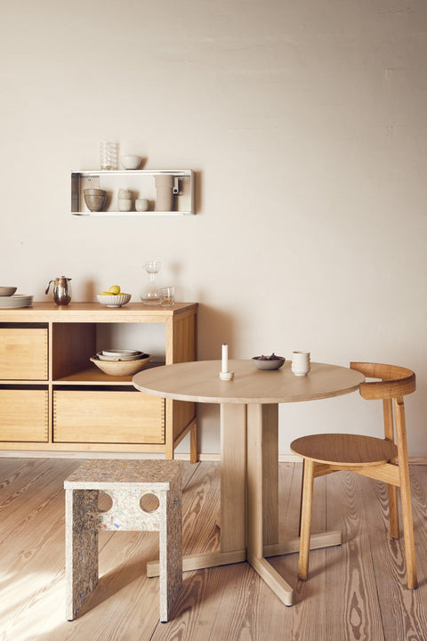 Form & Refine Taper Shelf 26x70, brushed stainless steel wall shelf, the small Taper shelf on a kitchen wall above a round table and the Remake stool
