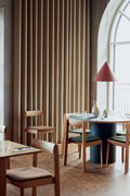 Form & Refine Trefoil Square Table, square oak dining table, square oak tables with Blueprint chairs in a café by a tall arched window