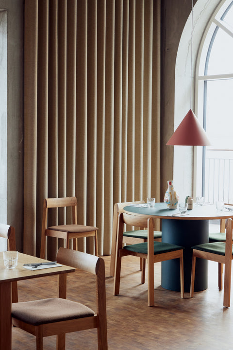 Form & Refine Trefoil Square Table, square oak dining table, square oak tables with Blueprint chairs in a café by a tall arched window