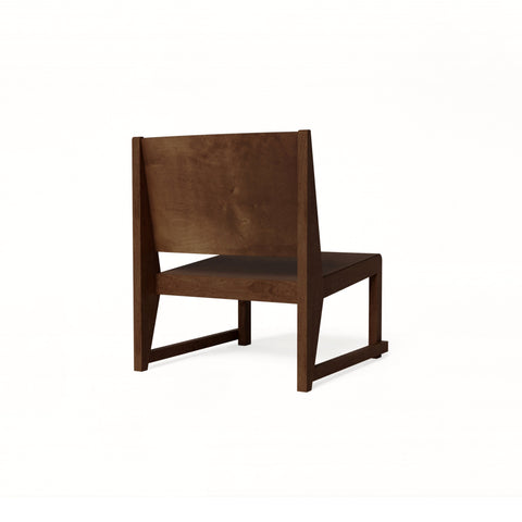 Frama Easy Chair 01 in Dark Brown Birch, low lounge chair with a wide flat back panel and sled legs, three quarter view on white