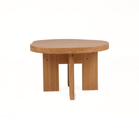 Frama Farmhouse Side Table in Natural Oak, pond shaped oak top on thick plank legs, three quarter view on white