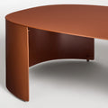 Bug Outdoor Coffee Table by Blu Dot in Rust, curved leg and matte aluminum surface detail