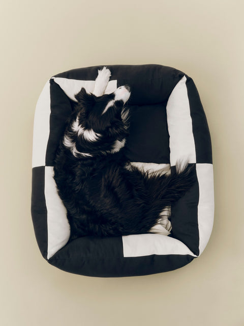 HAY Dog Bed Zip, Large, Black, White, recycled polyester dog bed, seen from above with a black and white dog sitting inside