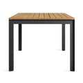 Hold Tight 76" Outdoor Dining Table by Blu Dot in Teak / Carbon, side view