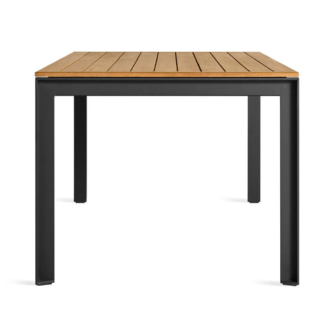 Hold Tight 76" Outdoor Dining Table by Blu Dot in Teak / Carbon, side view