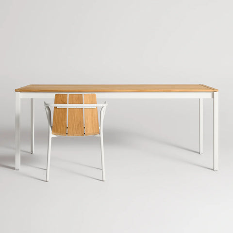 Hold Tight 76" Outdoor Dining Table by Blu Dot in Teak / White, styled with Offline Outdoor Chair, front view
