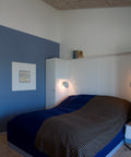 ph hat wall lamp designed by poul henningsen in a bedroom designed by louis poulsen