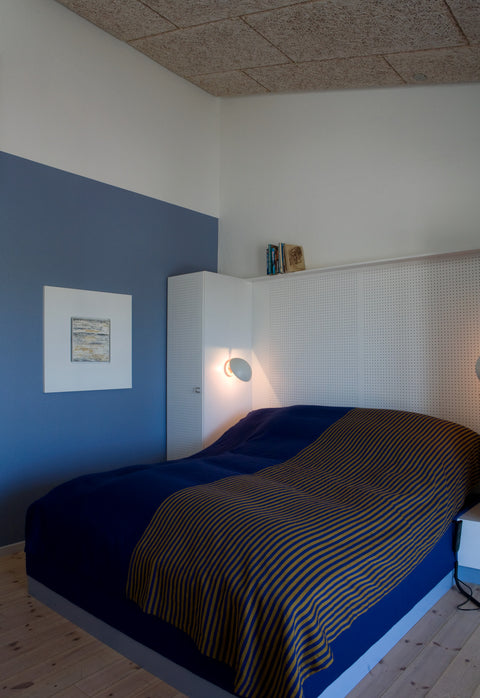 ph hat wall lamp designed by poul henningsen in a bedroom designed by louis poulsen