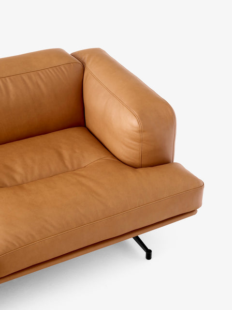 Close up of &Tradition Inland AV23 sofa in cognac leather showing armrest and cushion detail