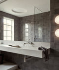 aj eklipta wall lamp by arne jacobsen for louis poulsen in a bathroom