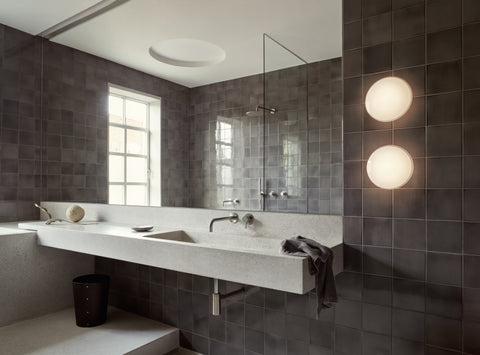 aj eklipta wall lamp by arne jacobsen for louis poulsen in a bathroom