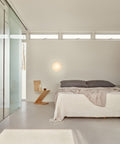 aj eklipta wall lamp in a modern bedroom designed by louis poulsen