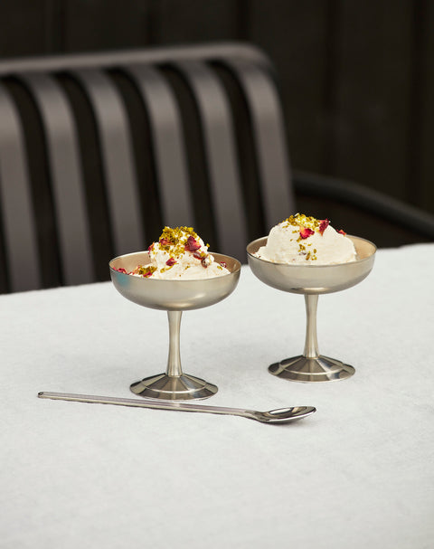 HAY Italian Ice Cup, Stainless Steel, stainless steel ice cream cup, two cups of cream dessert with pistachio on a white tablecloth