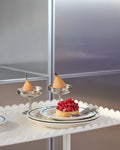 HAY Italian Ice Cup, Stainless Steel, stainless steel ice cream cup, two cups of peach dessert on a scalloped white trolley beside a berry tart