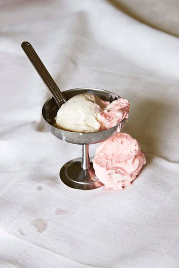 HAY Italian Ice Cup, Stainless Steel, stainless steel ice cream cup, holding vanilla and strawberry scoops with a spoon on white linen