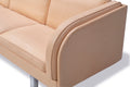 Close up of JG Sofa natural leather arm and seat with piping and brushed steel leg, premium Danish craftsmanship