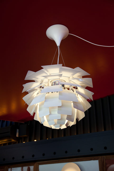 Close up of the Louis Poulsen PH Artichoke pendant in white showing layered shades and glare free light