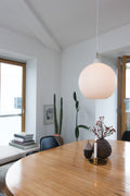 wohlert white pendant designed by Vilhelm Wohlert for Louis Poulsen above a dining room table in a scandinavian kitchen 