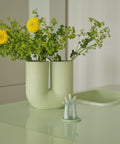 Muuto Kink Vase in modern living room decor with greenery