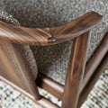 Close-up of Lanark Dining Chair finger-jointed wood detail on Classic Walnut armrest showing hand-carved craftsmanship