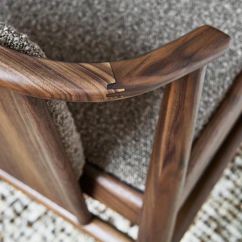 Close-up of Lanark Dining Chair finger-jointed wood detail on Classic Walnut armrest showing hand-carved craftsmanship