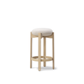Angled view of Fredericia Pioneer counter stool in oak with textured white seat highlighting rounded cushion and foot ring