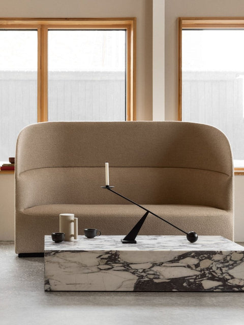Audo Copenhagen Tearoom Sofa, High Back, Tearoom Sofa, High Back with US Power Outlet in beige, set against a window with a marble coffee table