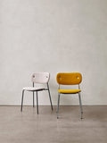 Audo Copenhagen Co Dining Chair, Without Arms, Fully Upholstered, fully upholstered Co Dining Chairs. One in off-white bouclé with a black frame, one in yellow with a chrome frame