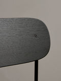 Audo Copenhagen Co Bar Chair, Non-Upholstered, close-up view of the Co Bar Chair's backrest in black stained oak veneer, highlighting the rich wood grain and screw